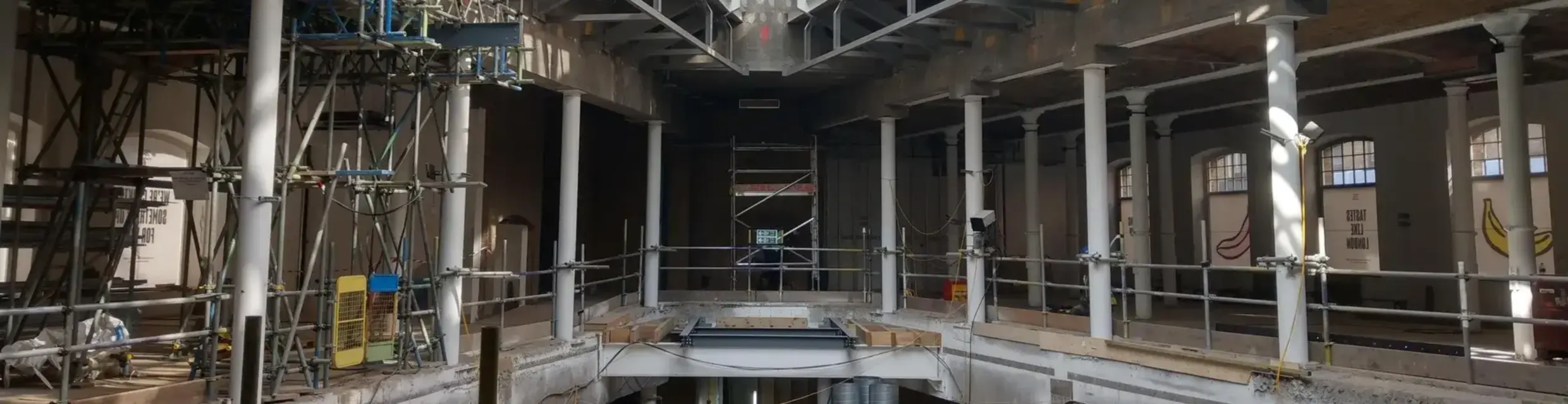 Internal fitout of commercial building with scaffolding and glass roof